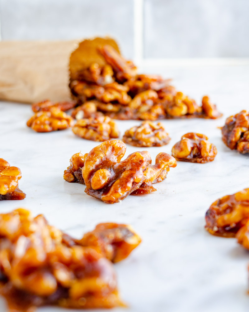 Candied walnuts spilling out of a bag.