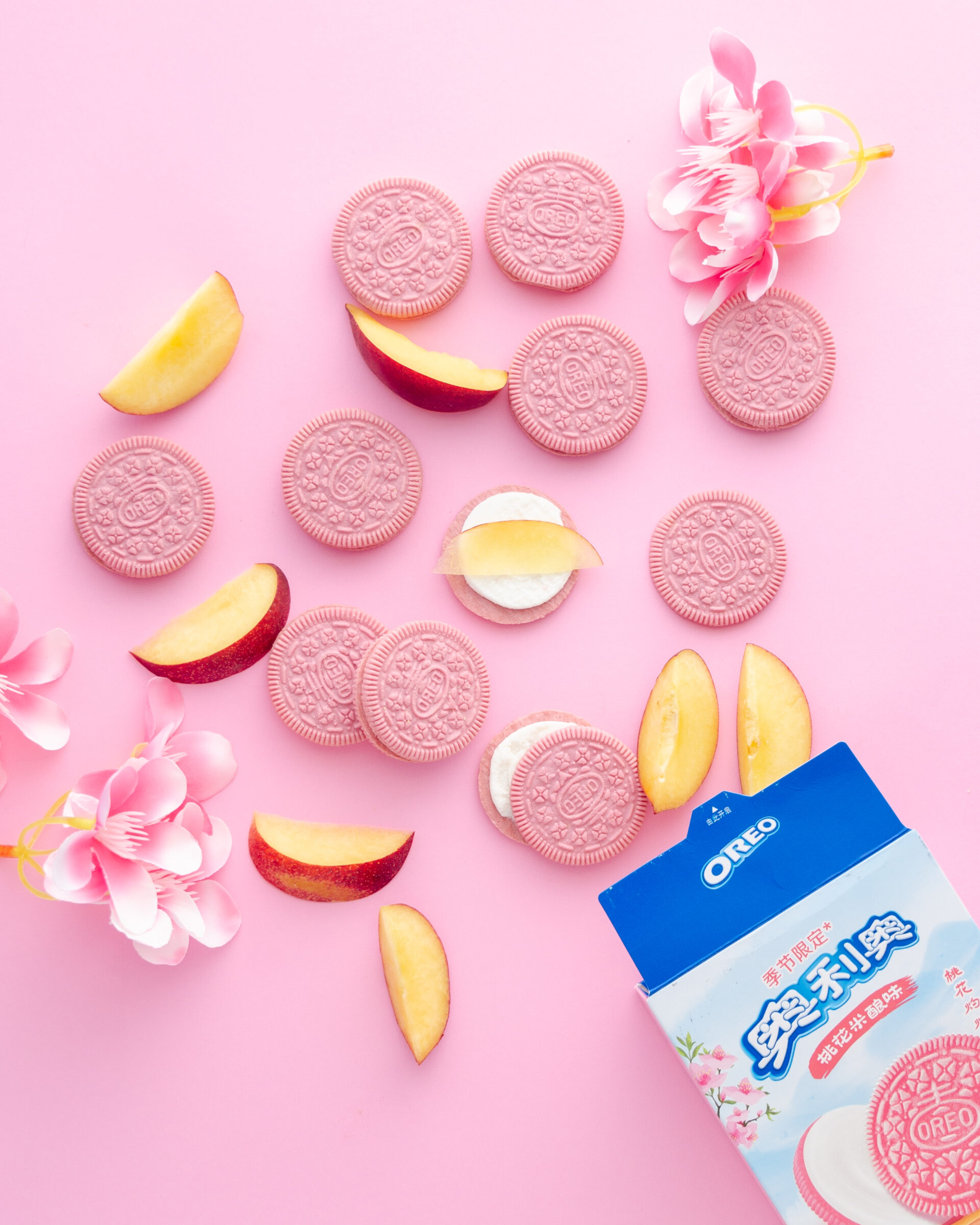 brand photography of peach blossom oreos spilling out of a bax.