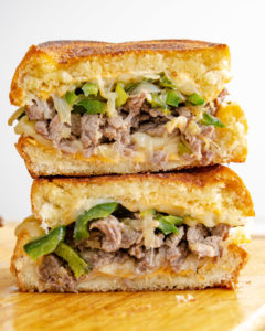 Philly Cheesesteak Stacked on a cutting board - Food Photography